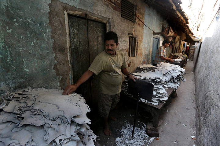 Tannery workers in India: Leather pieces are softened outside a tannery 