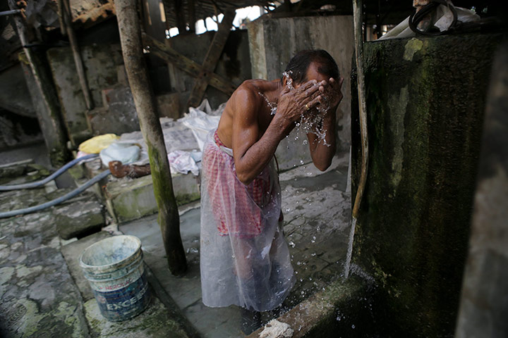 Tannery workers in India: A laborer washes his face after finishing a day's work