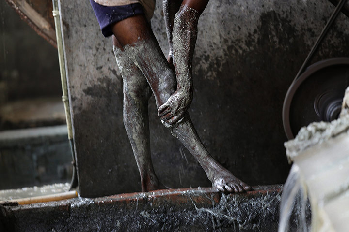 Tannery workers in India: Hanif Muhammad washes chemicals off his legs after a process called 'fleshi