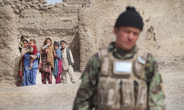Kandahar, Afghanistan: An Afghan National Army (ANA) soldier walks through a village during a joint patrol with the US Army.