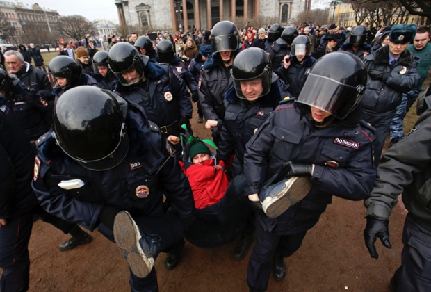 St. Petersburg, Russia: Interior Ministry members detain a protester during a rally near Saint Isaac's Cathedral (Isaakievskiy Sobor) . People gathered  to protest against the possible military incursions of the Russian army onto the territory of Ukraine.