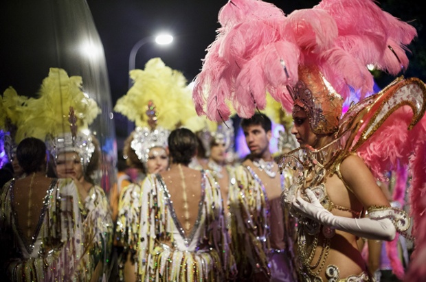 Santa Cruz De Tenerife, Spain:  A member of 'Valleiros' checks her costume reflected on a van window before performing on the troupes dancing contest.