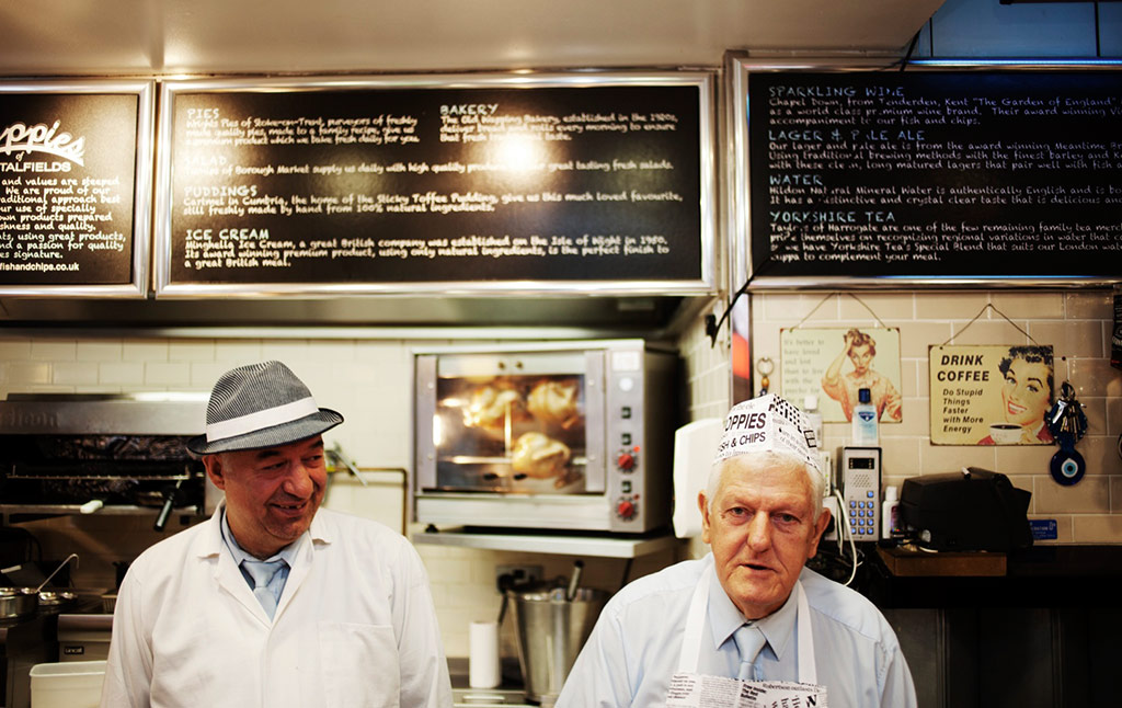 2 men working in local fish and chip shop