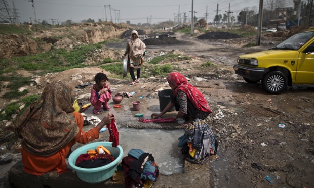 Pakistani women wash their laundry at a water reservoir, on the outskirts of Islamabad.
