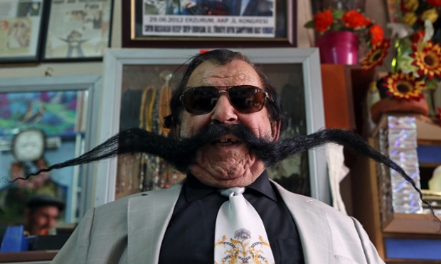 Haci Kilic with his 1.5 metre long moustache in his barbershop in Erzurum, Turkey. Kilic has not cut it for thirty years and wraps his moustache around his head when as works.