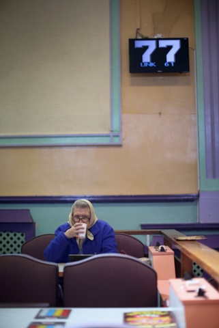 Lucky seven’s: A woman plays Bingo at Carlton Bingo Hall in Orrell Park,