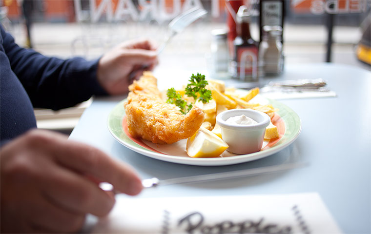 A customer tucks into a fish dinner.