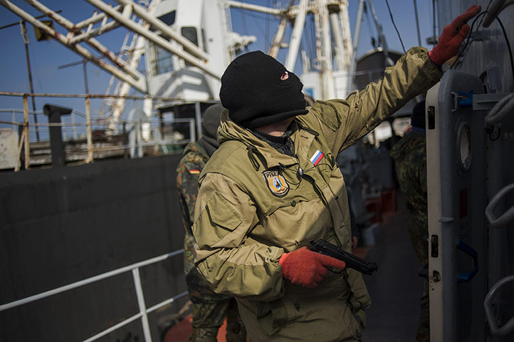 20 Photos: A member of a pro-Russian force on the Ukrainian corvette Khmelnitsky