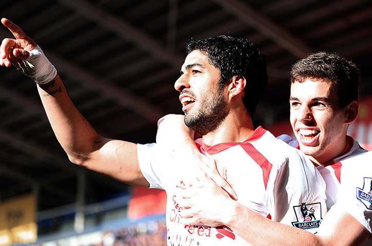 saturday round up: Liverpool's Luis Suarez celebrates scoring his sides fourth goal 