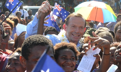 Prime Minister Tony Abbott is surrounded by schoolchildren during a visit to Koki primary school in Port Moresby, Saturday, March, 22, 2014. Mr Abbott made a three day state visit to Papua New Guinea.