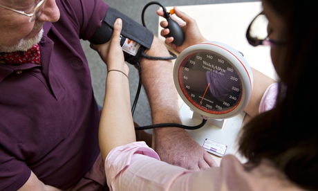 GP taking blood pressure