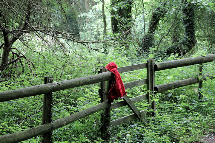 In Pictures - Lost: child's red coat hanging on fence in park