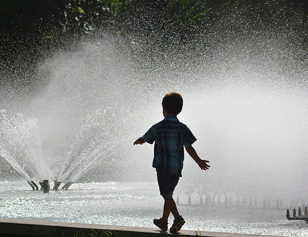 In Pictures - Lost: picture of boy walking beside a fountain