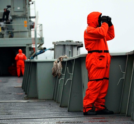 Crew members of the Australian Navy ship, HMAS Success, look for any potential sightings for debris in the southern Indian Ocean during the search for missing Malaysian Airlines Flight MH370.