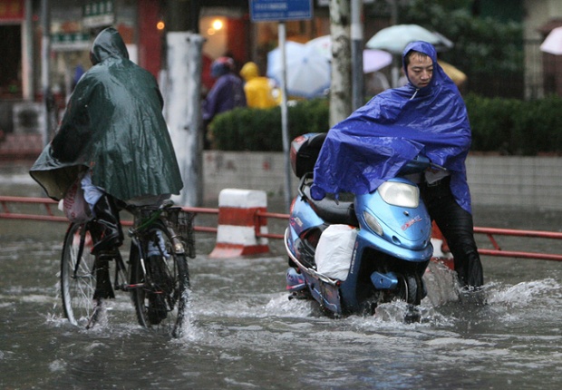 Shanghai residents struggle through flooded roads as a typhoon bears down on the city