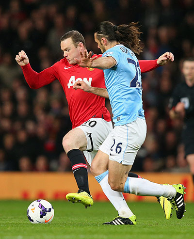 United v city:  Martin Demichelis keeps a close eye on Wayne Rooney 