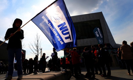 A boy in Liverpool waves a flag in support of the Nation Union of Teachers (NUT) during a one-day strike by teachers across England and Wales.