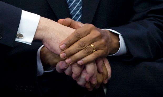 Power shake: President Barack Obama shakes hands with Herman Van Rompuy and Jose Manuel Barroso in Brussels.