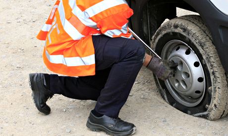 Breakdown recovery man changes the tyre
