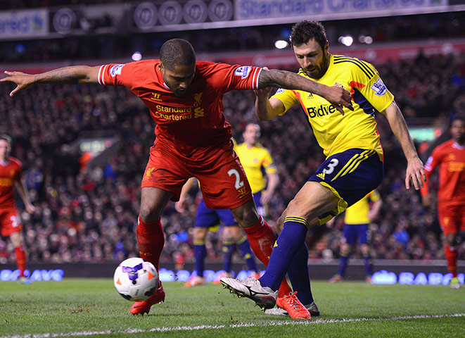 Liverpool Sunderland: Andrea Dossena clears from Glen Johnson 