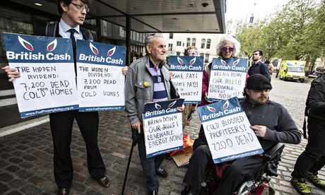 Campaigners against high fuel prices with placards protest at a British Gas shareholder meeting 