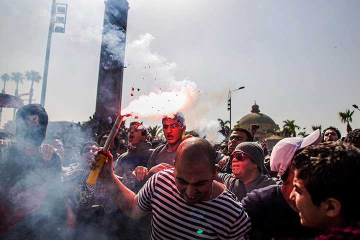 20 Photos: A supporters of ousted President Mohammed Morsi fires a flare in Giza