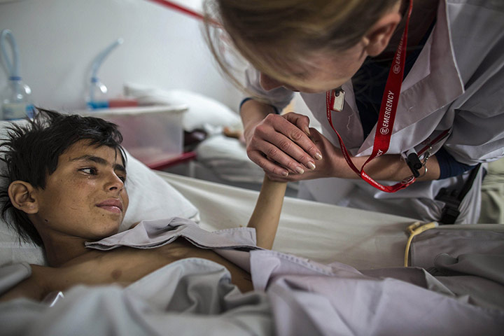 20 Photos: Gullali, who sustained bullets injuries, is comforted by a nurse in Kabul