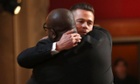 Steve McQueen and Brad Pitt embrace on stage at this year's Oscars.