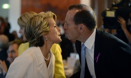 Tony Abbott greets Julie Bishop as they attend the International Women's Day Parliamentary Breakfast.
