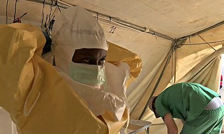 Nurses put on protective gear to treat Ebola patients in the southern Guinean town of Gueckedou