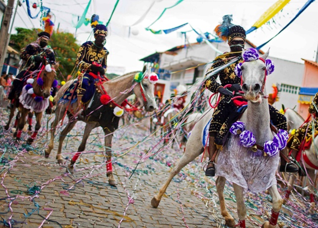 Revellers participate in the traditional Carnival on horseback in Bonfim, Brazil.