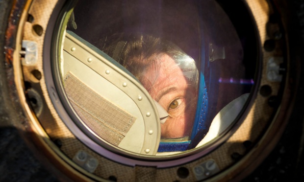 Expedition 27 flight engineer Cady Coleman peeks out of a window of the Soyuz TMA-20 spacecraft shortly after she, commander Dmitry Kondratyev and flight engineer Paolo Nespoli landed south-east of the town of Zhezkazgan, in Kazakhstan