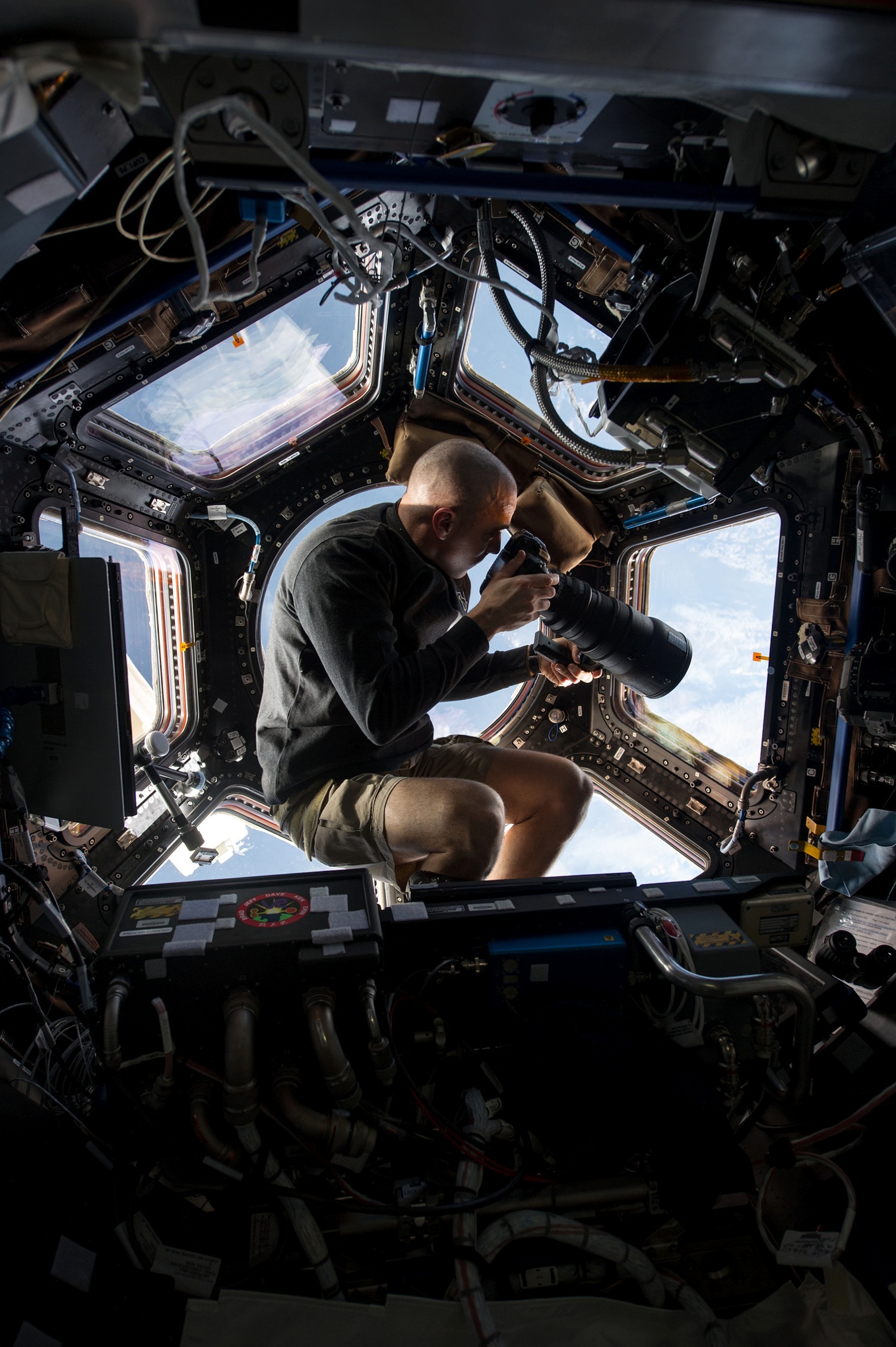 From the cupola, Chris Cassidy, an Expedition 36 flight engineer, uses a 400mm lens on a digital still camera to photograph Earth, some 250 miles below him, and the International Space Station