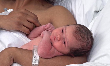 Mother in bed with newborn baby