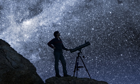 Man Stargazing in Desert