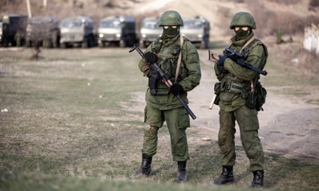 Alleged Russian soldiers in full body armour and armed with assault rifles next to the besieged Ukrainian military base in Perevalnoye close to Simferopol.