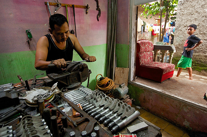 Air rifle capital: A gunsmith shapes a part of a trigger assembly