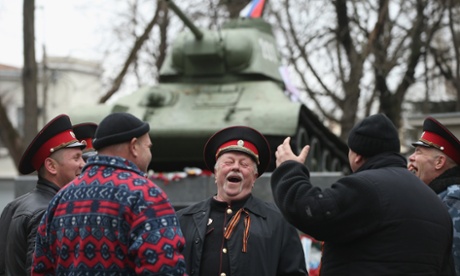 Pro-Russian Cossacks share a laugh next to a war monument in Simferopol.