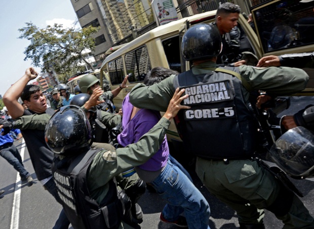 Venezuelan National Guard members arrest opposition activists during a protest against the government of President Nicolas Maduro.