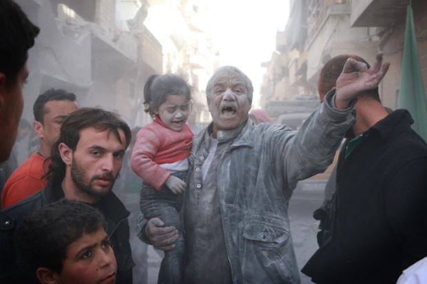 A Syrian man holds a crying girl after being caught in an air strike by government forces on the Sahour neighbourhood of the northern Syrian city of Aleppo.