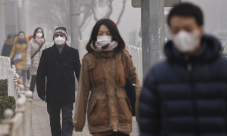 Chinese citizens wear masks on their faces on a hazy day in Beijing, January 2014.