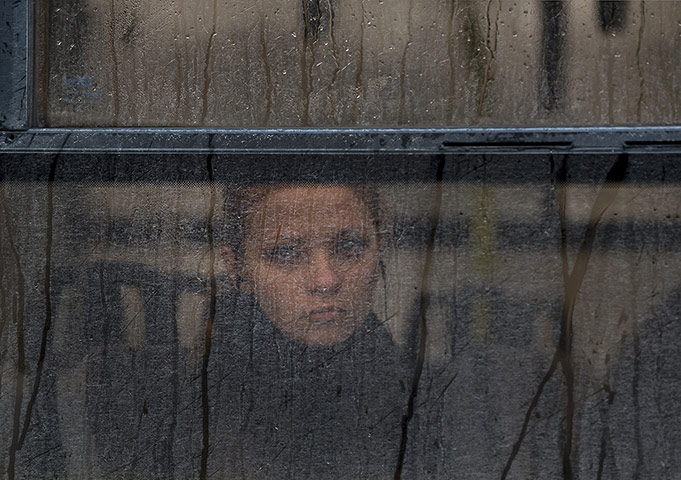 20 Photos: A woman watches a rally against the breakup of Ukraine in Simferopol