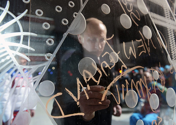 20 Photos: Vladimir Putin signs his name at the Paralympic village outside Sochi