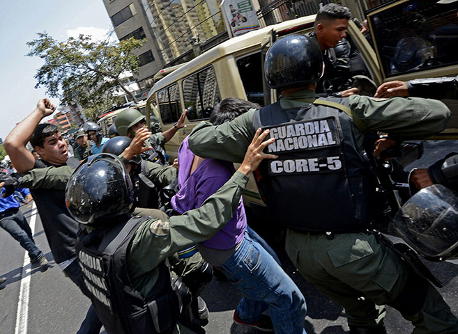 20 Photos: Venezuelan National Guard members arrest an opposition activist in Caracas