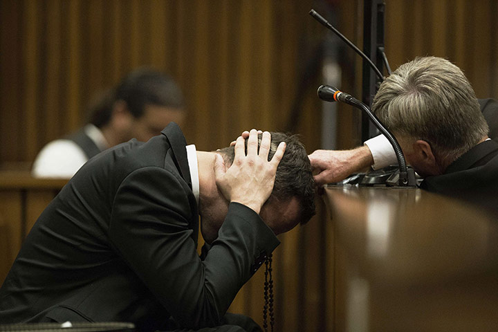 20 Photos: A member of Oscar Pistorius' legal team reaches out to him