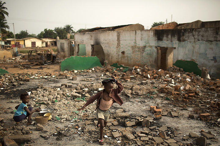 20 Photos: A girl walks through rubble of demolished Muslims homes in Bangui