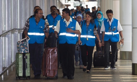 Relatives of passengers on the missing Malaysia Airlines flight MH370 arrive at the Family Friend reception centre at Kuala Lumpur International airport.