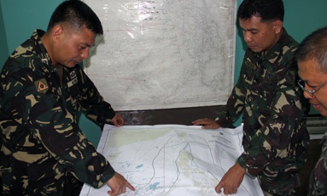 Philippines military personnel plan search and rescue operations for the missing Malaysia Airlines plane at Antonio Bautista air base in Puerto Princesa.