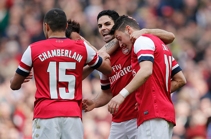 Arsenal versus Everton: Mesut Ozil is congratulated by team-mates