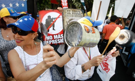 Marchers in Caracas bang pots in protest at food shortages.